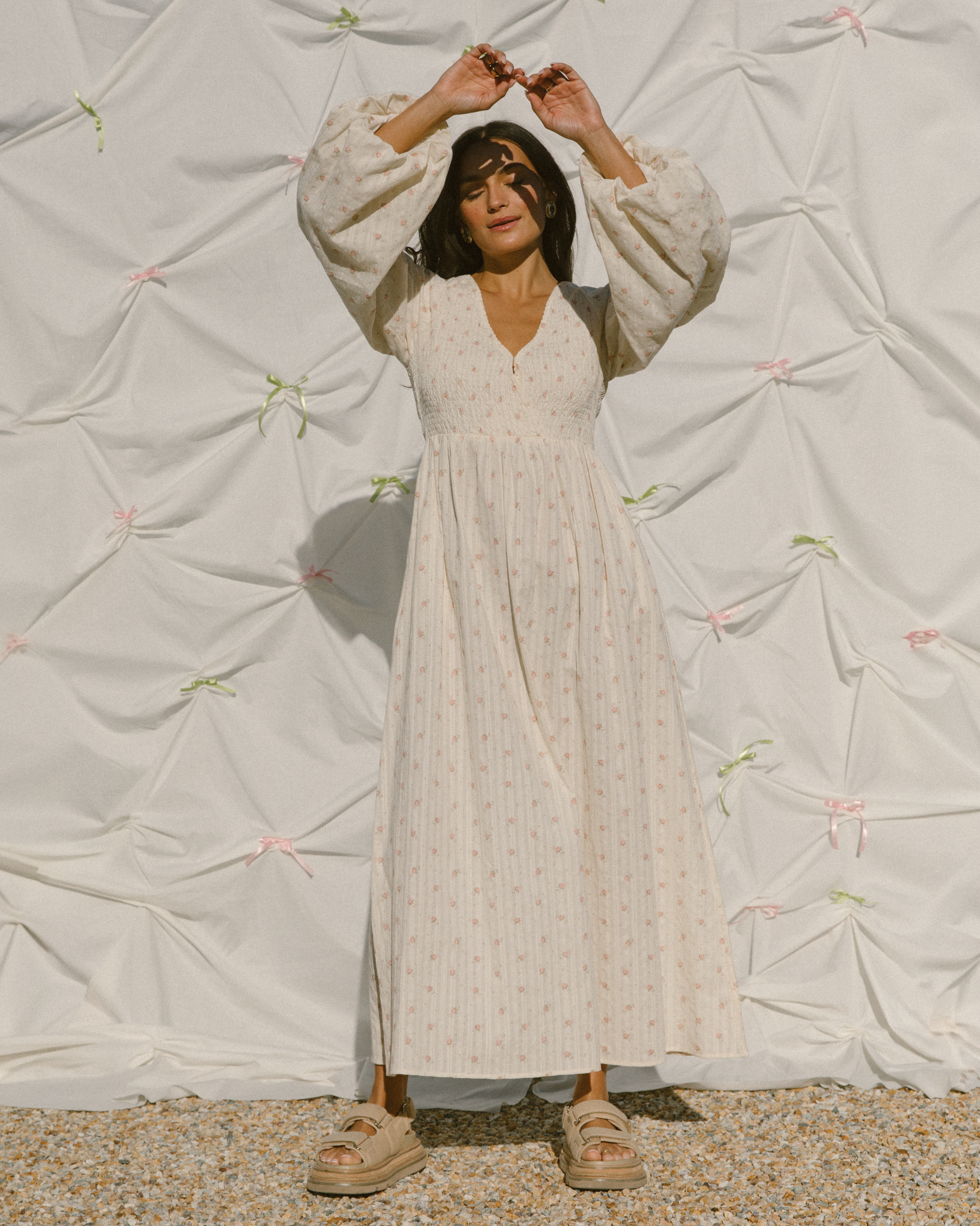 Woman wearing maxi dress with shirred bust and modesty clip.