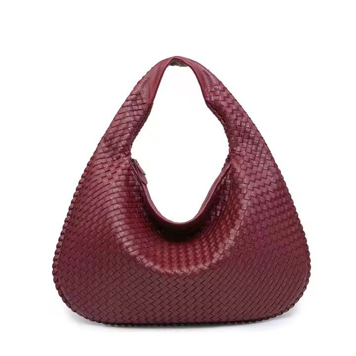 Maroon woven handbag on a white background