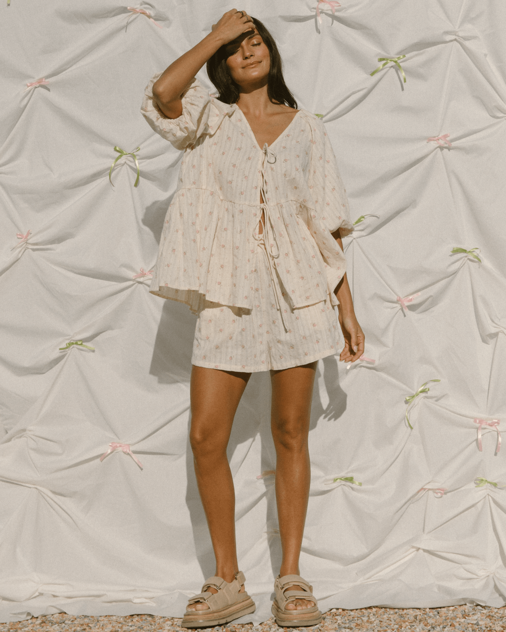 Woman wearing trendy matching set with tie-up front, breastfeeding access and oversized style.