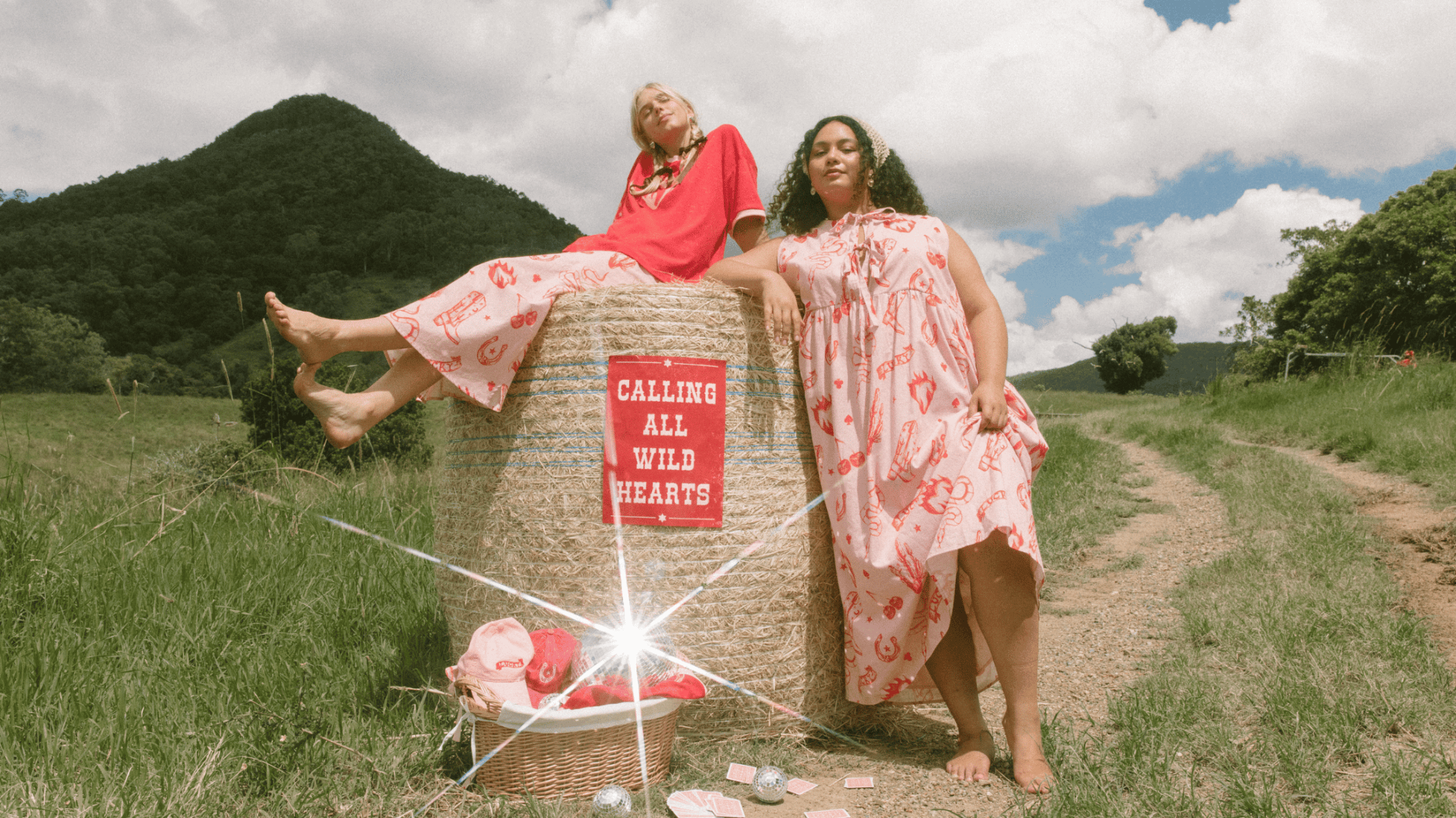 Three women wearing linen printed sets, relaxed sitting on stairs outside in a fashionable manner