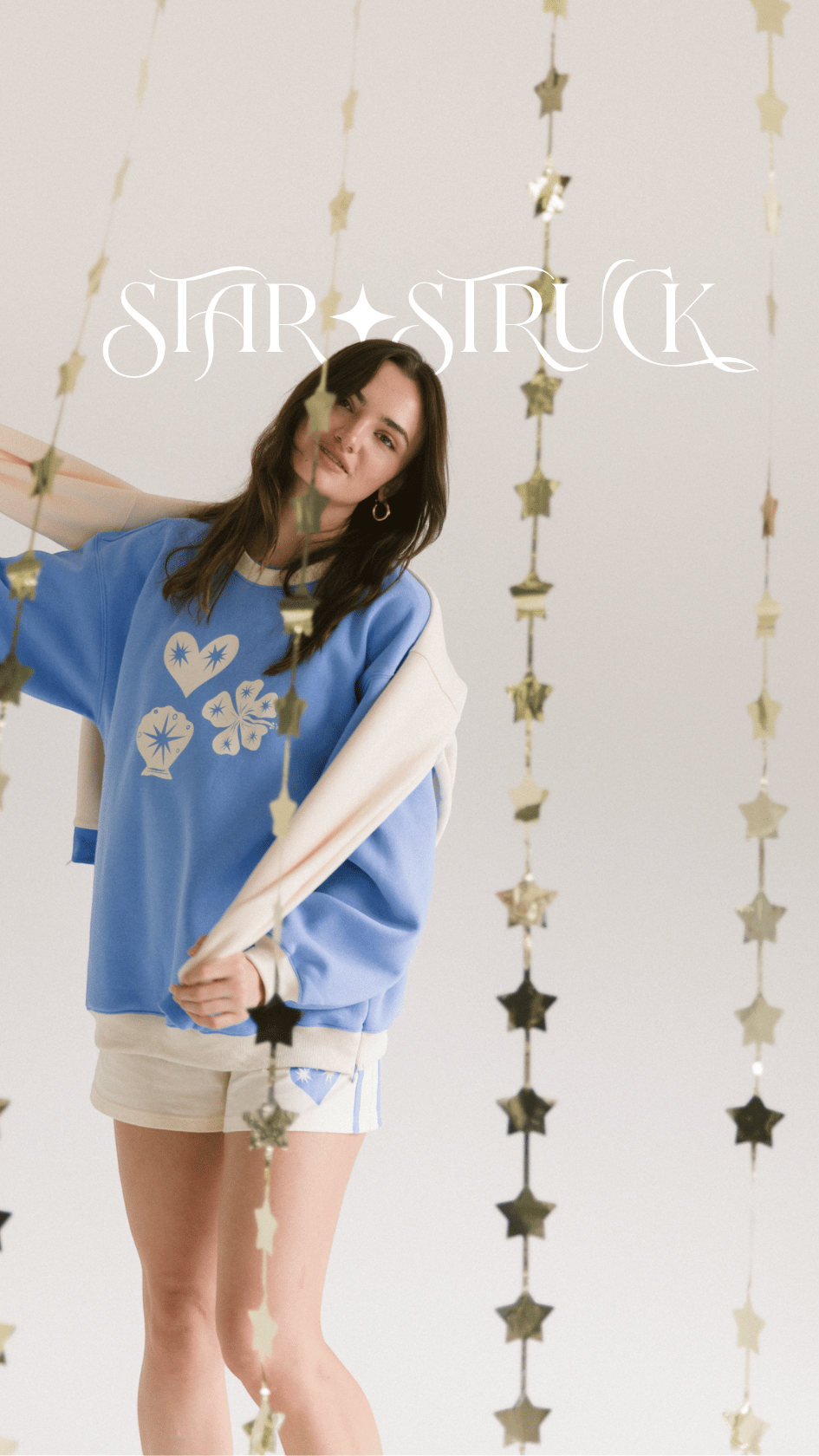 Models wearing The Lullaby Club Essentials Sets and Slouchy Jumpers in cream and cobalt blue. Featuring cozy winter loungewear with breastfeeding-friendly zips and relaxed fits. Designed for modern mums and everyday ease.