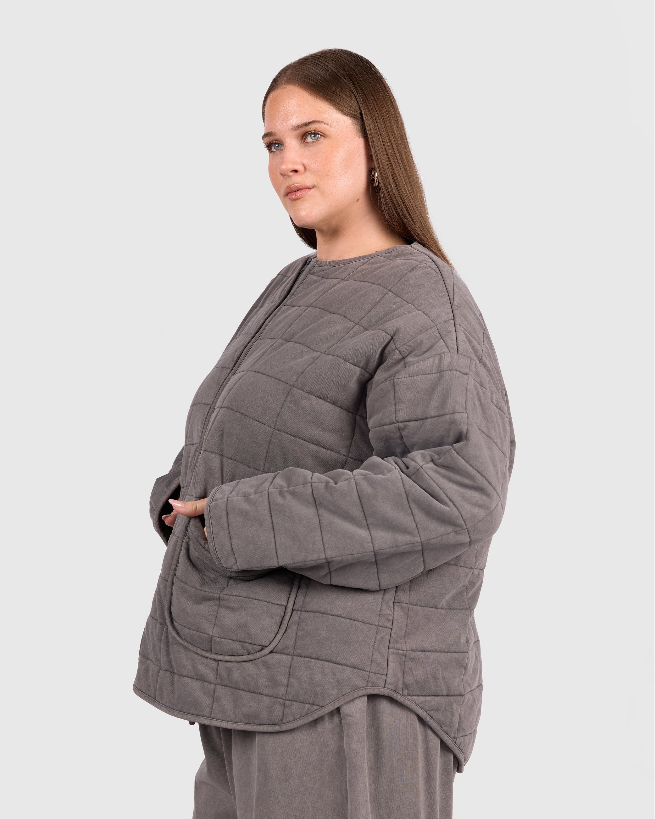 Woman wearing quilted winter charcoal jacket with pockets