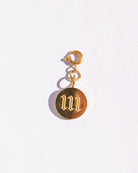 Gold circle charm with angel numbers '11' on a white background