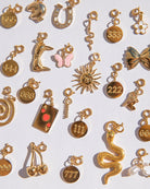 Collection of various gold charms on a white background