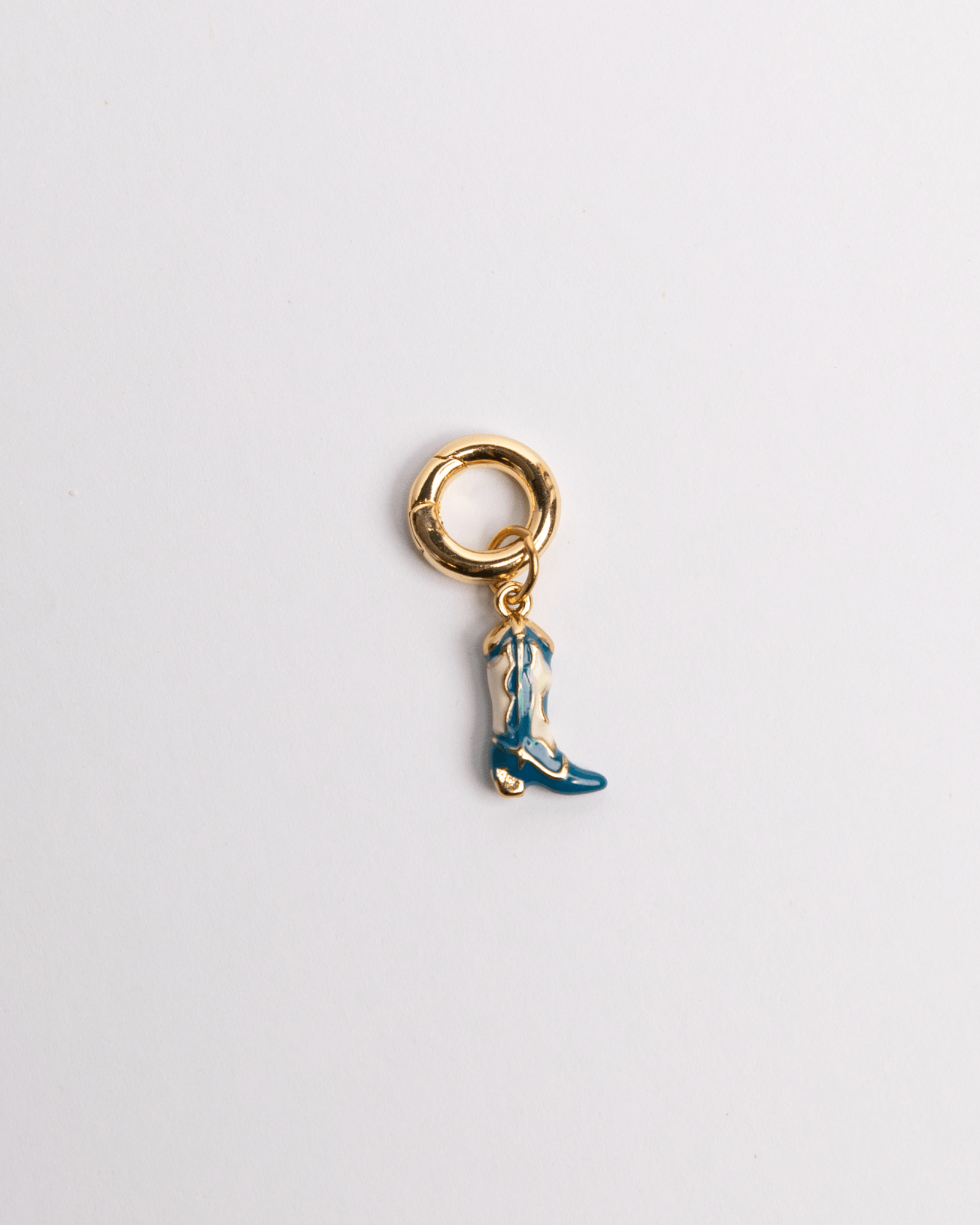 A blue boot charm with a gold-colored clasp and detailing on a white background.