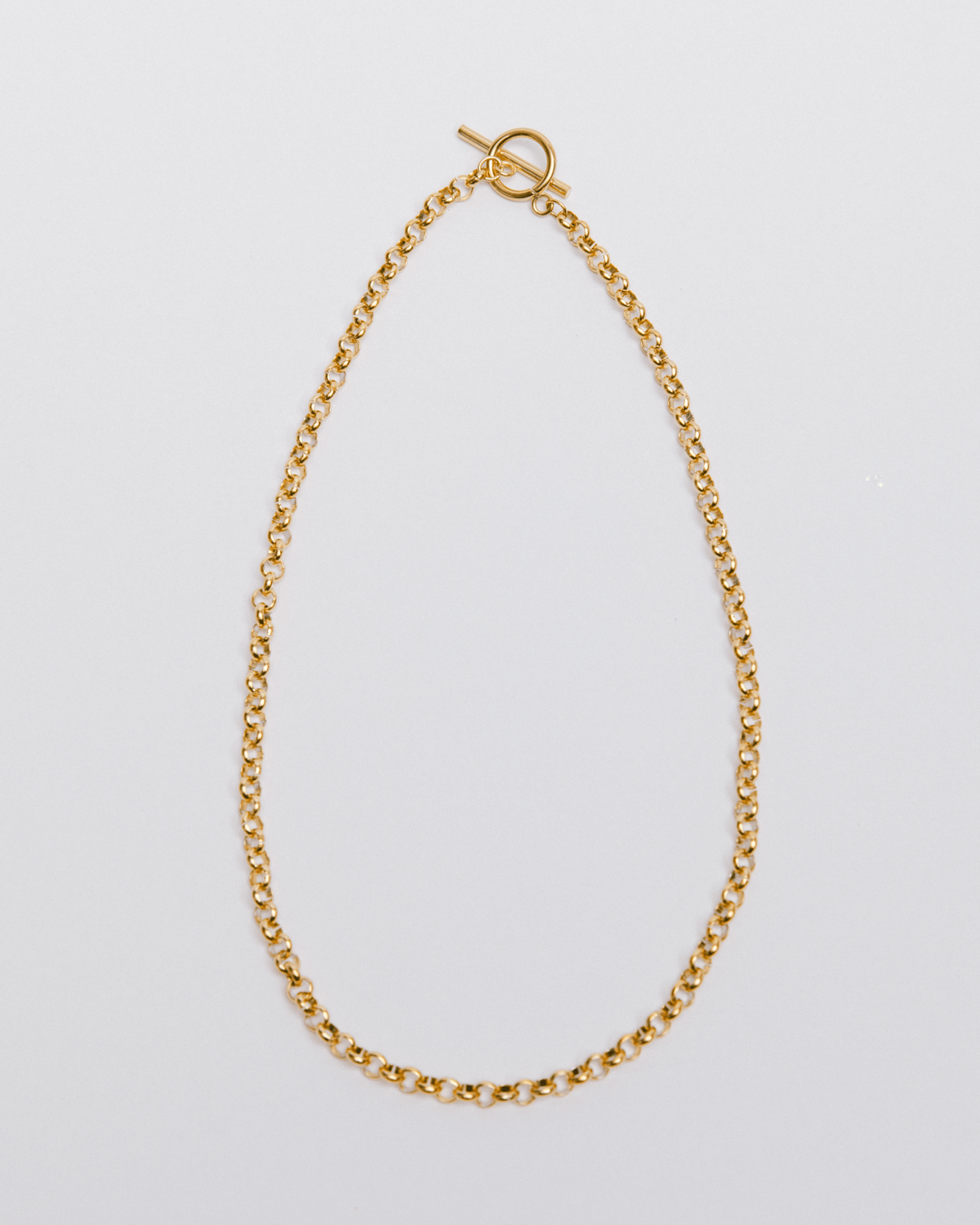 A chunky gold toggle necklace with a classic chain design, displayed against a white background.