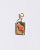 Gold pendant shaped like an Ace of Hearts card on a white background
