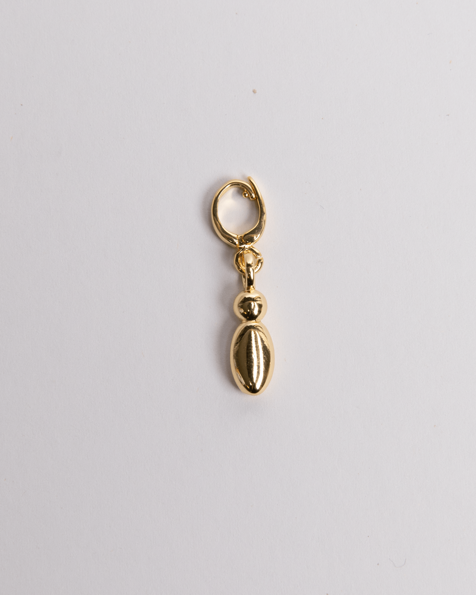 A gold-colored lowercase 'I" charm in a bubble style with a clasp, placed against a white background.