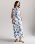 Woman wearing a blue floral dress on a plain background