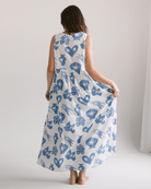 Woman wearing flowy and breathable maxi dress in a blue and white star print. 