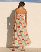 Woman wearing a colourful spring strapless dress. 