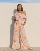 Woman wearing a stylish spring outfit in a light pink floral design.