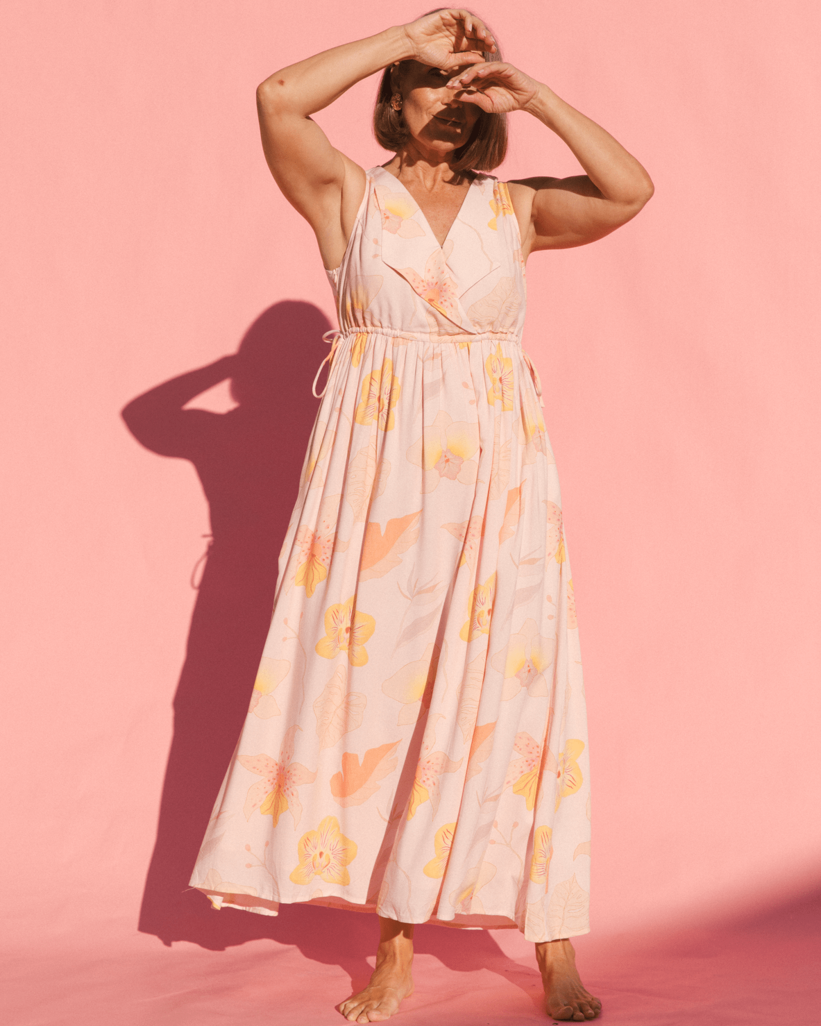 Woman wearing floral breastfeeding friendly dress. 