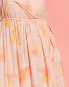 Woman wearing light pink floral bump-friendly maxi dress