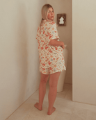 Woman wearing a floral pajama set.