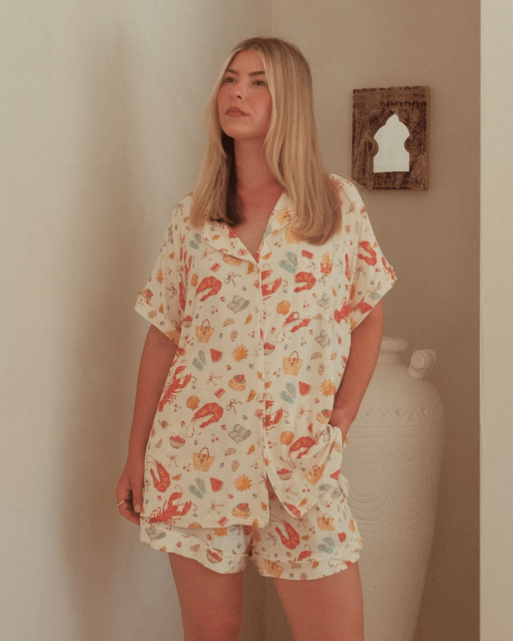 Woman wearing summer matching pyjama set that features an aussie christmas print. 