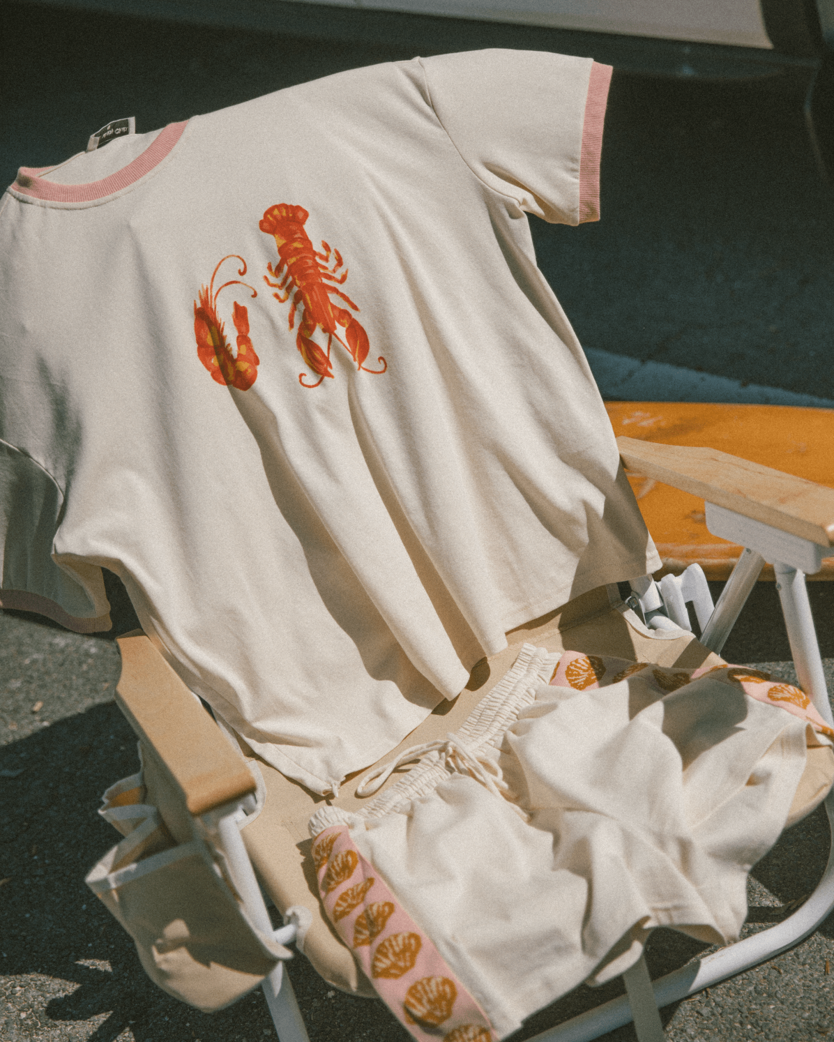 Beige outfit with lobster design on a chair outdoors